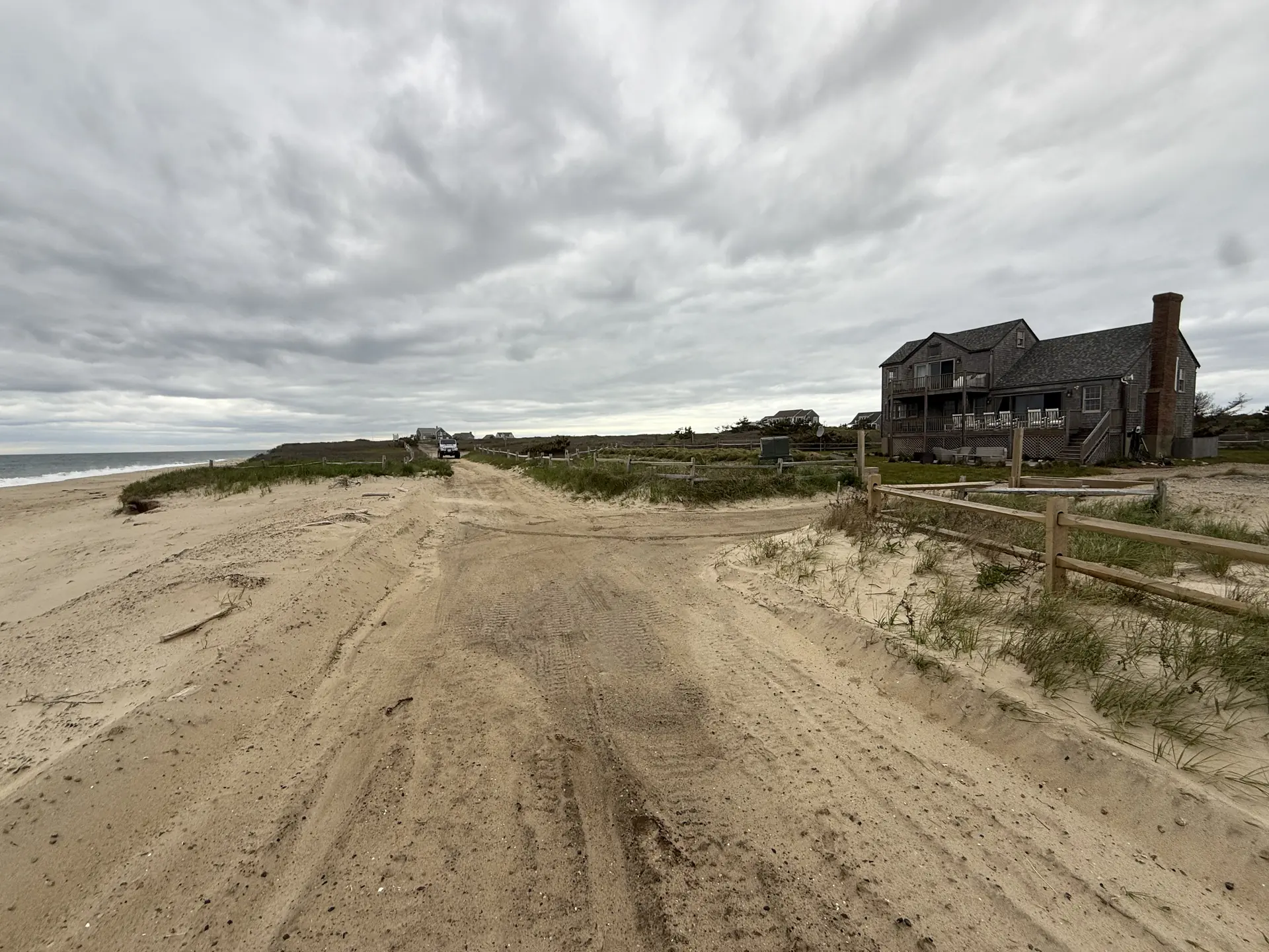 Shingled Nantucket beach house in the dunes at golden hour