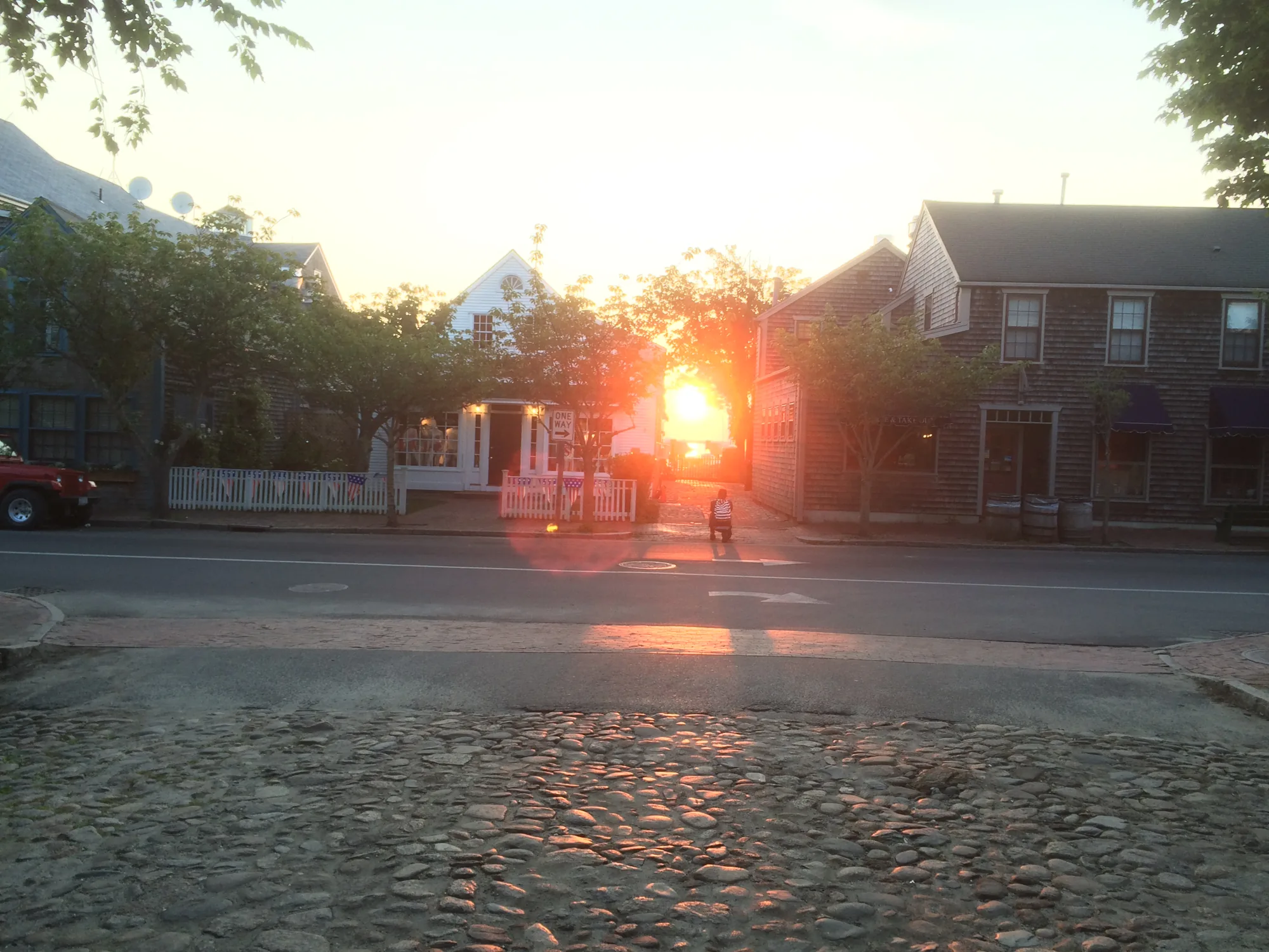 Cobblestone downtown Nantucket real estate street at golden hour