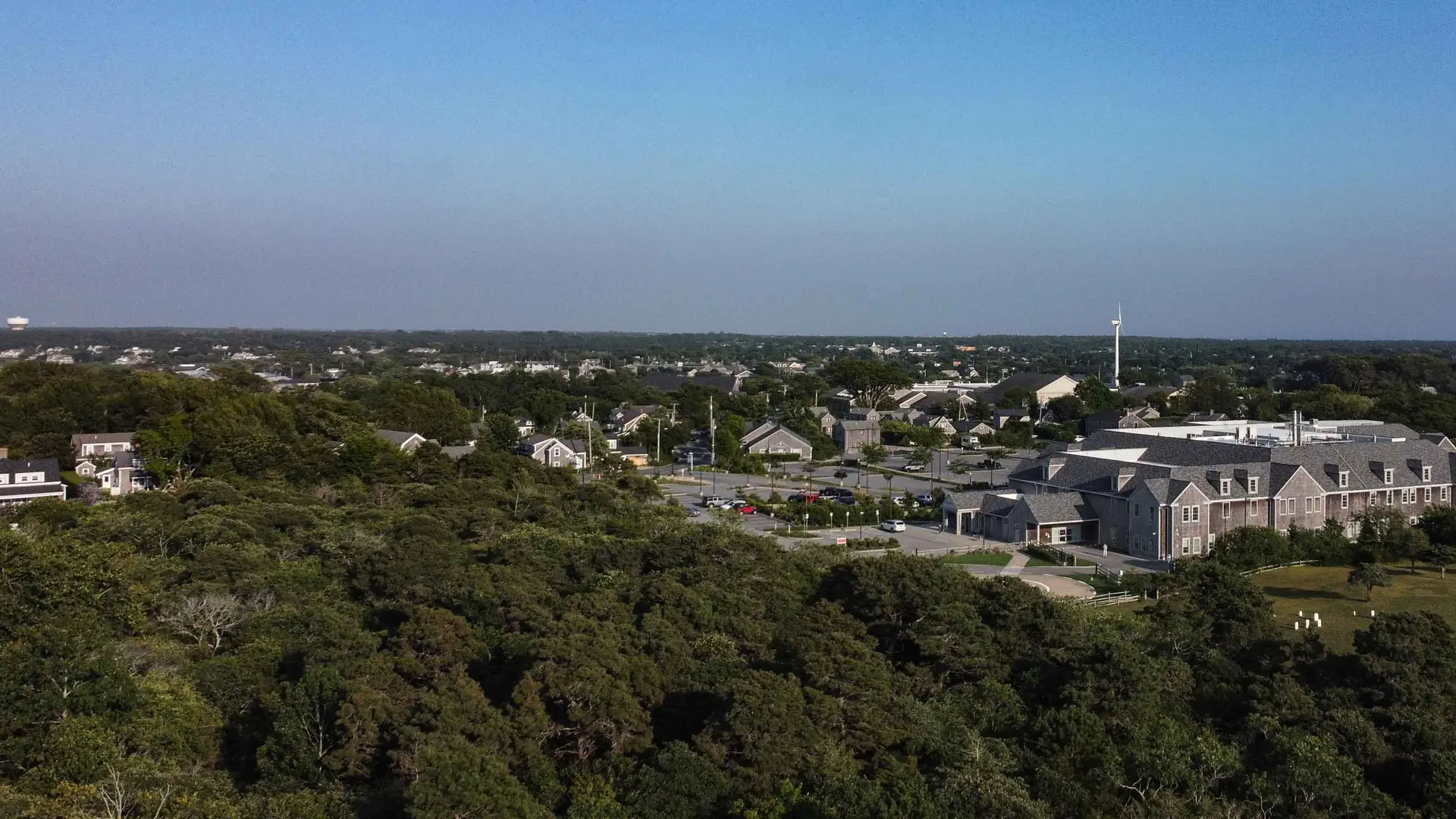 Aerial view over Mid Island, Nantucket, across rooftops, trees and the island's year-round neighborhoods