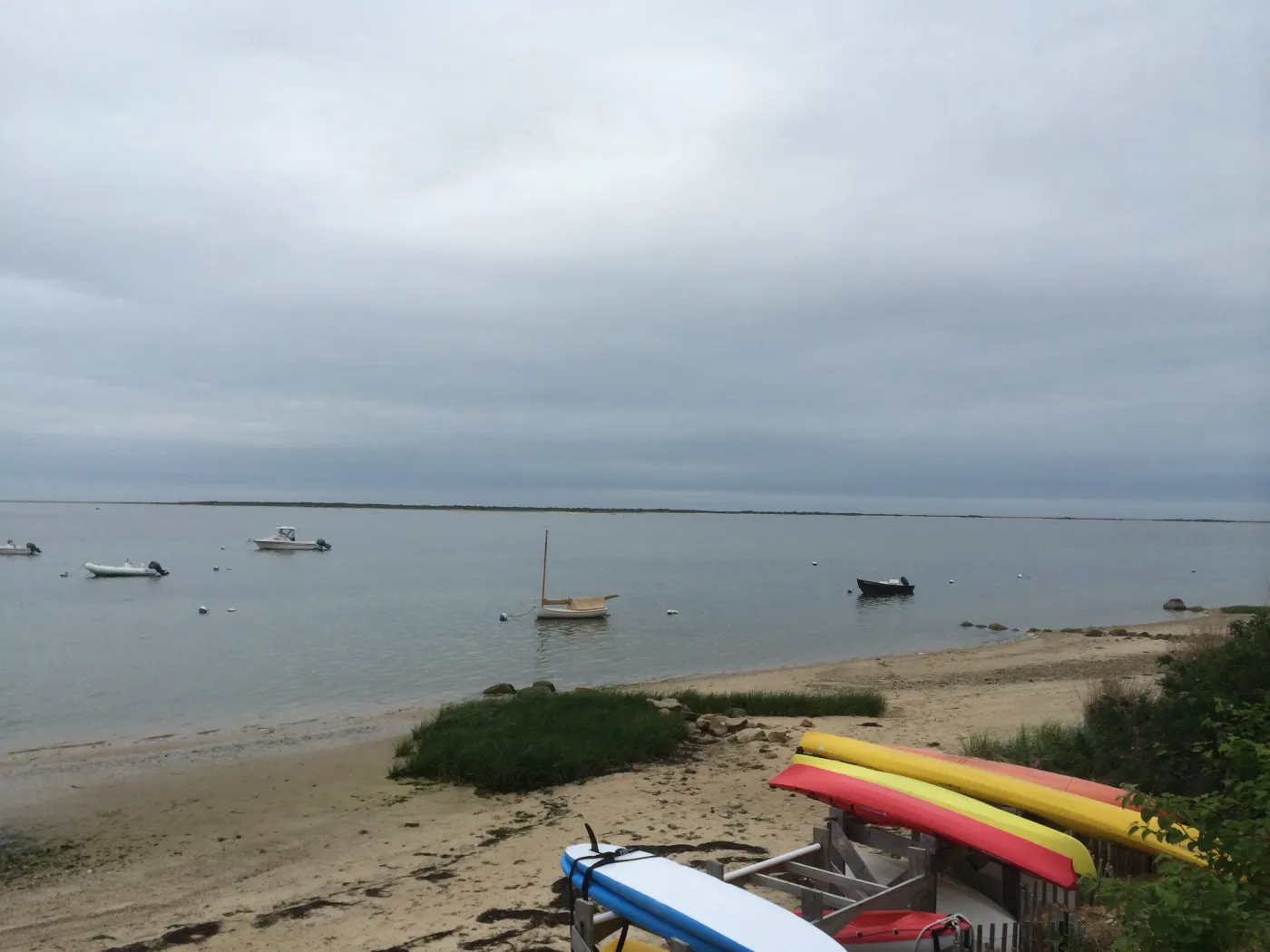 Boats moored off a calm harbor beach at Monomoy, Nantucket