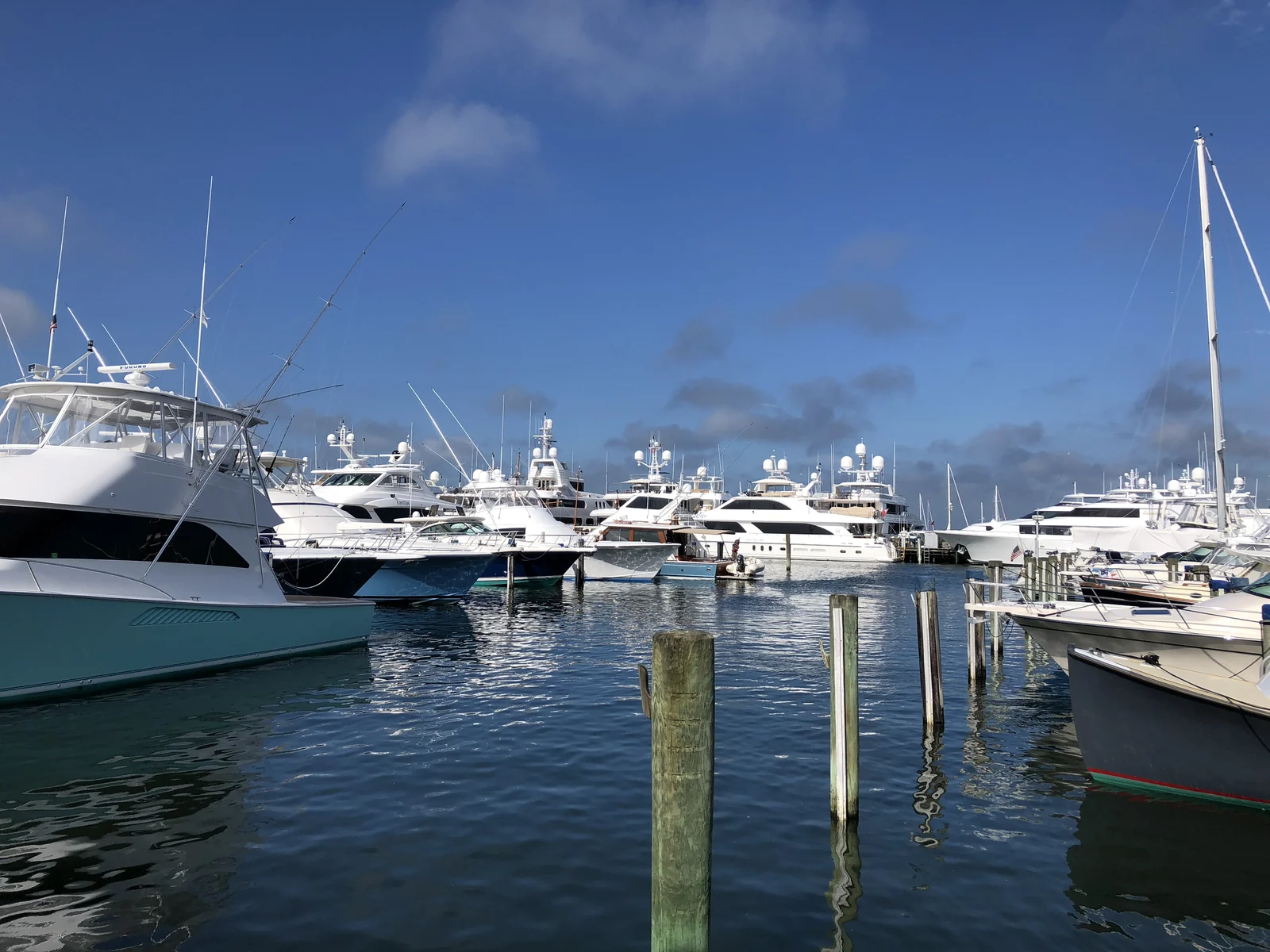 Boats moored in the Nantucket Boat Basin with the town's shingled rooftops beyond
