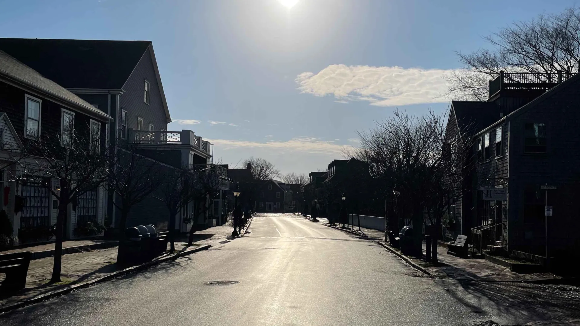 Downtown Nantucket on a quiet winter morning, shop fronts and brick sidewalks with no summer crowds — the year-round island the residential exemption exists for