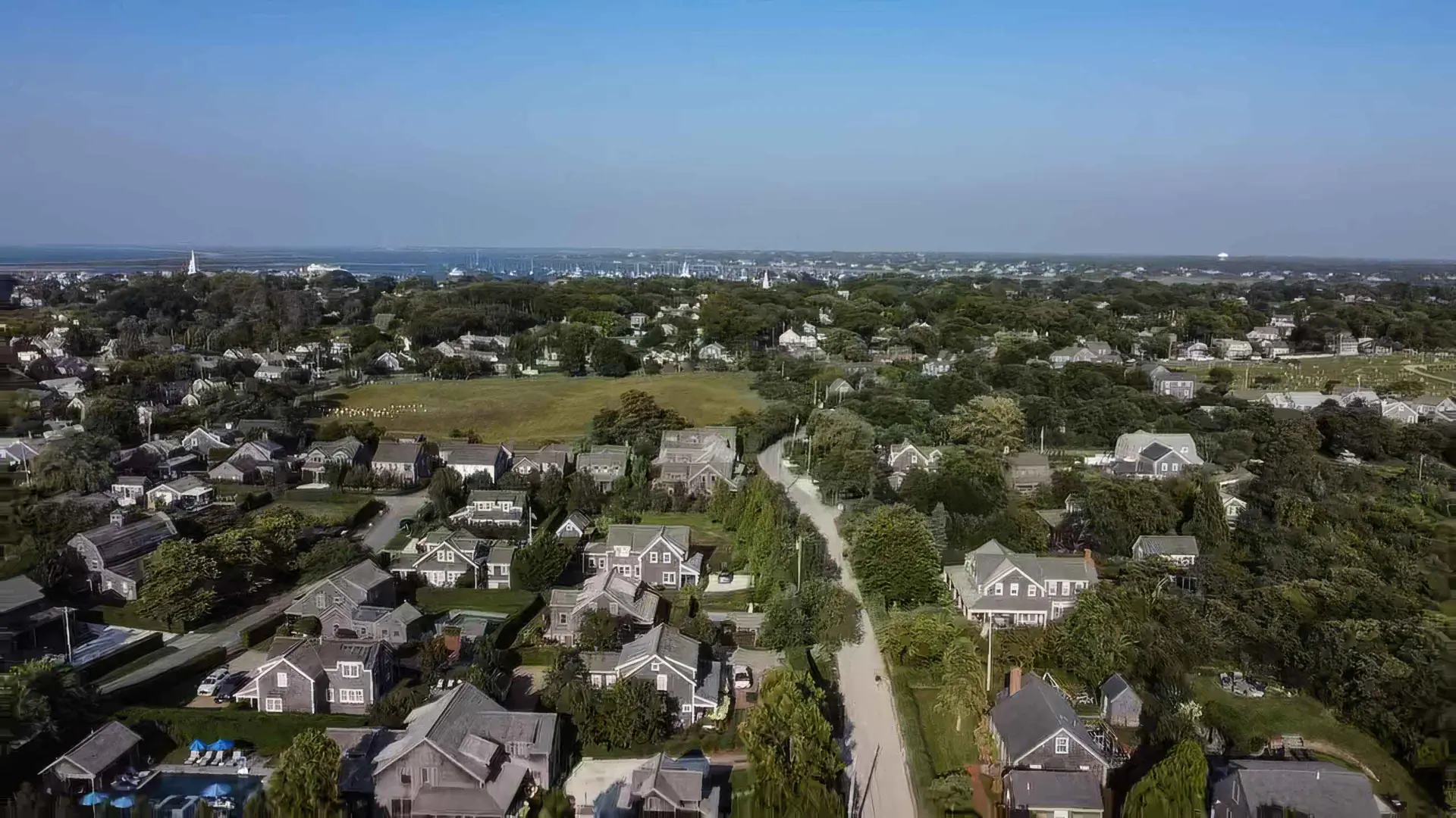 Aerial view over West of Town, Nantucket, across rooftops toward the harbor